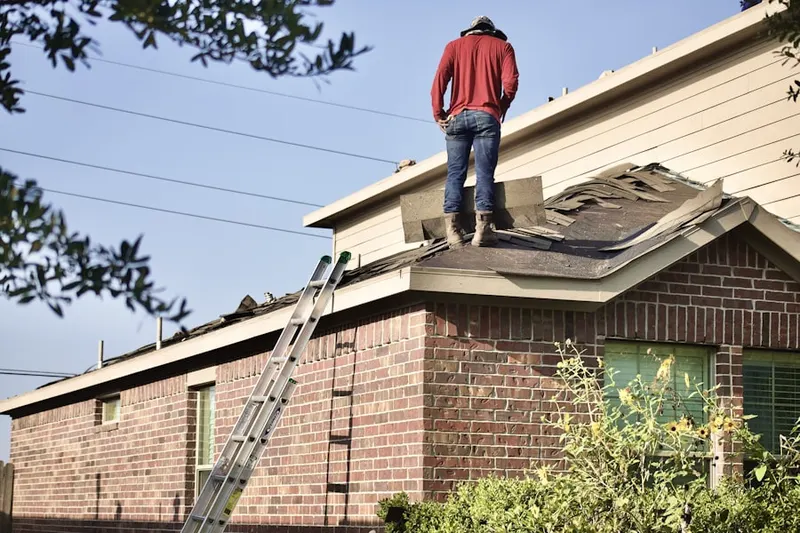 Professional roofer working on a residential roof in Sekitan